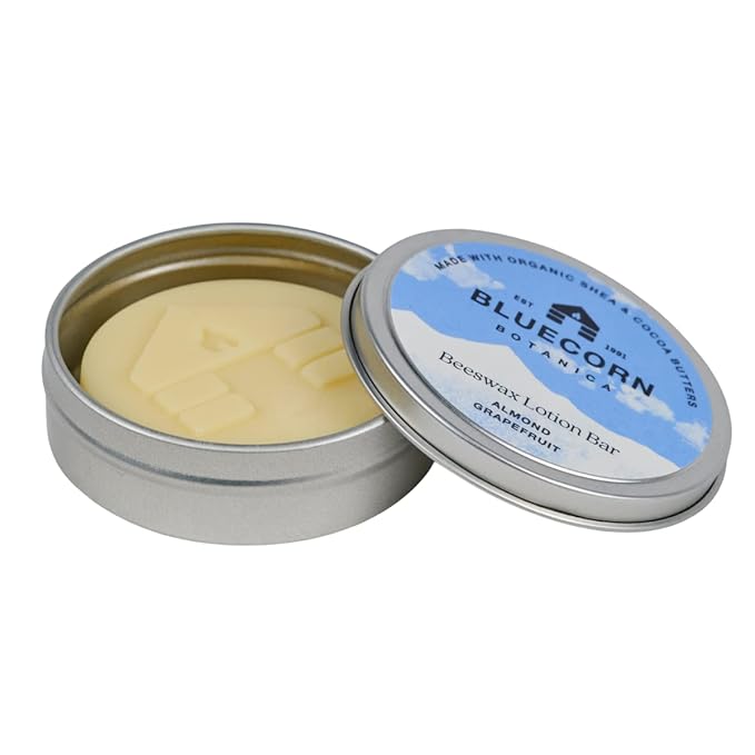 Bluecorn Beeswax Ultra-Moisturizing Lotion Bar. Almond Grapefruit Scent. Organic Shea Butter, Cocoa Butter, Vitamin E, Apricot Oil & Avocado Oil. 1.5 oz Plastic-Free Travel Tin. Handmade in Colorado.
