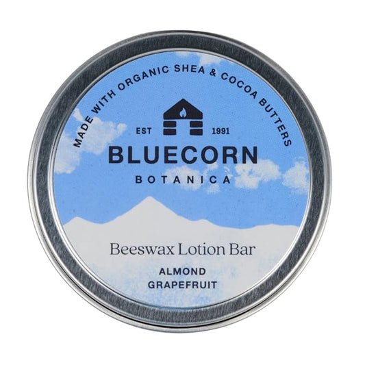 Bluecorn Beeswax Ultra-Moisturizing Lotion Bar. Almond Grapefruit Scent. Organic Shea Butter, Cocoa Butter, Vitamin E, Apricot Oil & Avocado Oil. 1.5 oz Plastic-Free Travel Tin. Handmade in Colorado.
